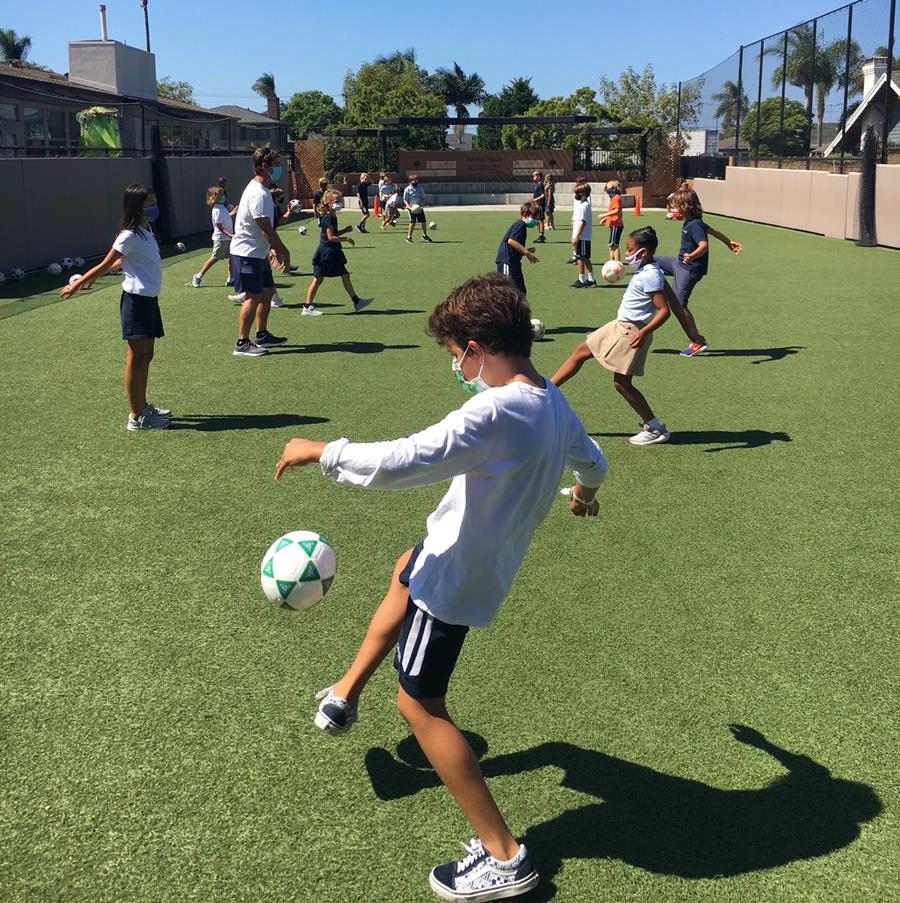 kids playing soccer on the field