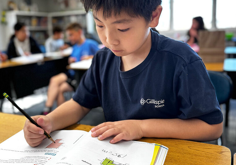 Apply to Gillispie School Grade 4 Gillispie School student tackles math problem in class